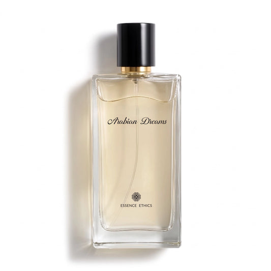 Arabian Dreams perfume by ESSENCE ETHICS in a clear glass bottle with pale golden liquid and a black cap on a white background.