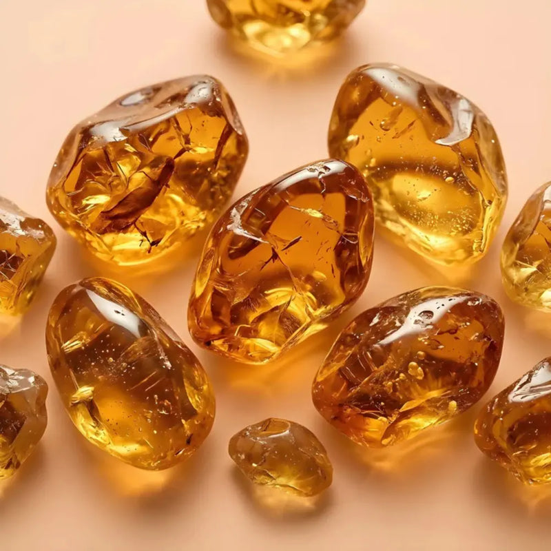 Transparent amber stones on a peach background fragrance note