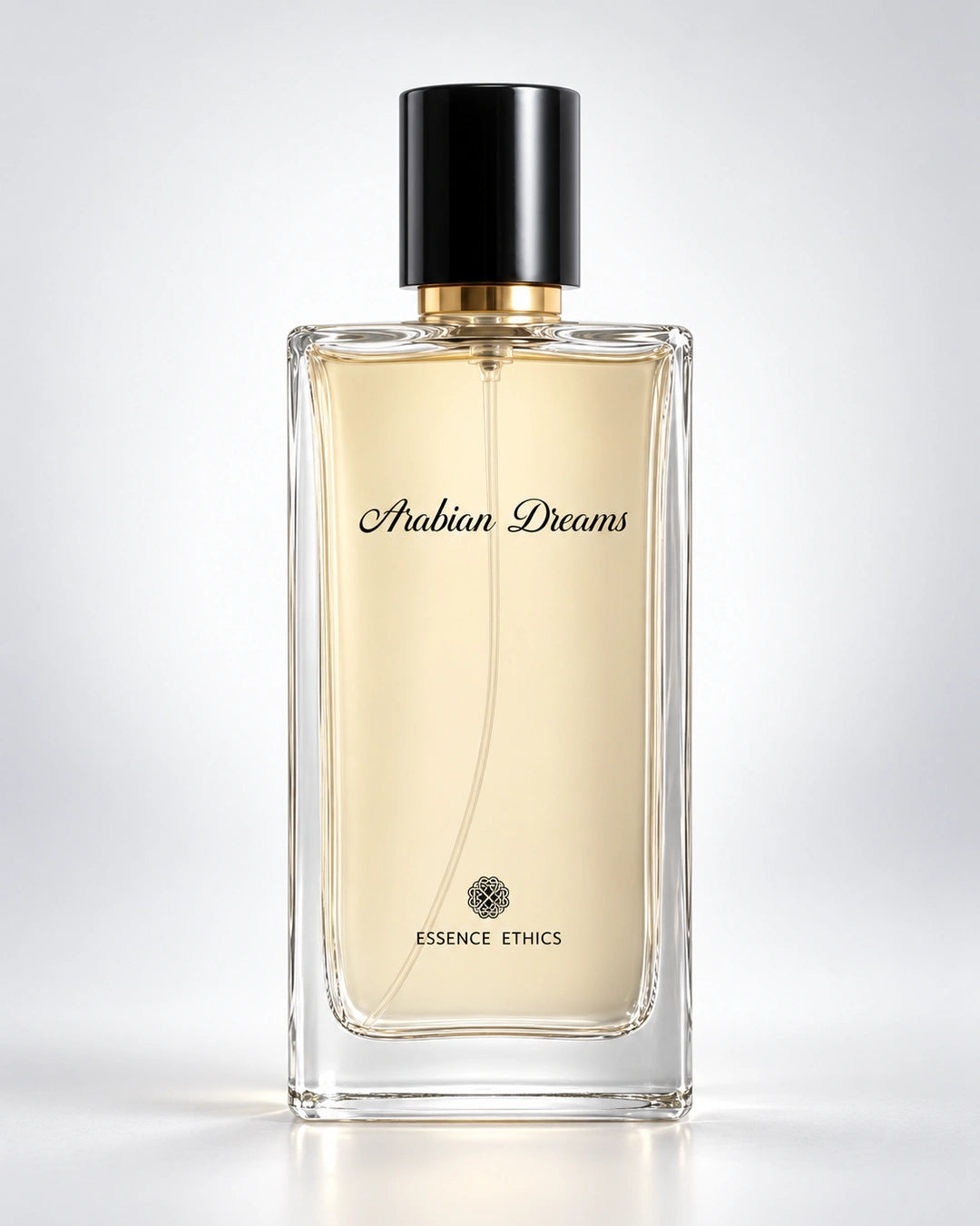 Arabian Dreams perfume by ESSENCE ETHICS in a clear glass bottle against a soft white and light grey background.