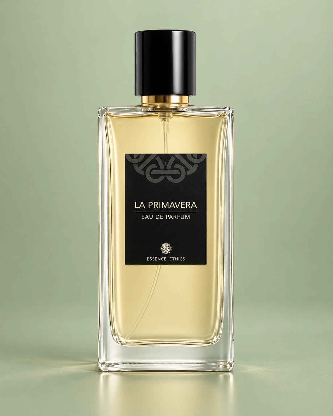 La Primavera perfume by ESSENCE ETHICS in a clear glass bottle with a black cap against a soft sage green background.