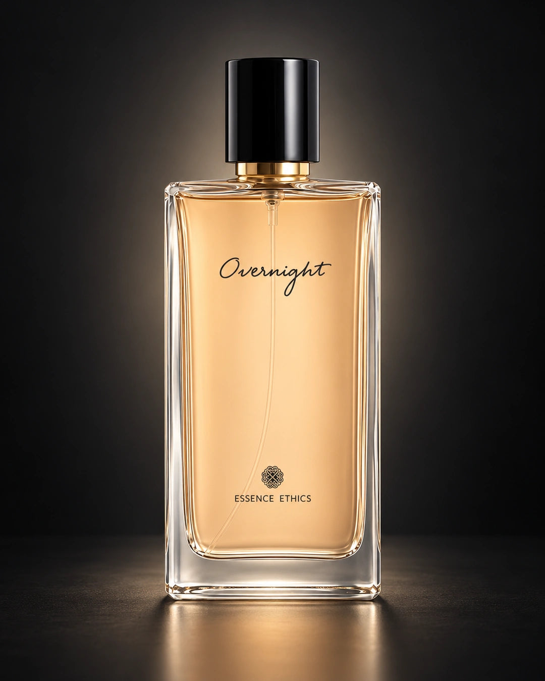 Overnight perfume by ESSENCE ETHICS in a clear glass bottle against a black background with soft backlighting.